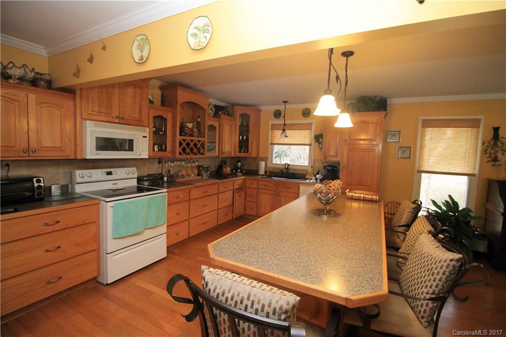 1748 Boyd Road Blackstock, SC 29014 - Photo 16 of 24 a kitchen with a table chairs stove and cabinets