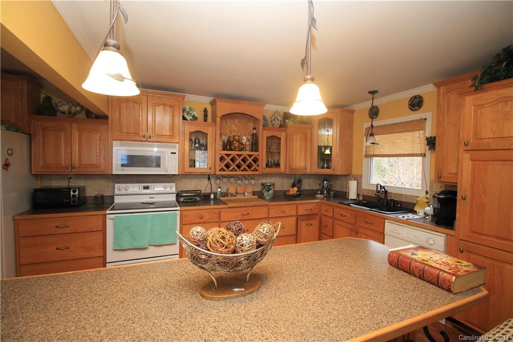 1748 Boyd Road Blackstock, SC 29014 - Photo 17 of 24 a large kitchen with stainless steel appliances granite countertop a sink a stove and a wooden floors