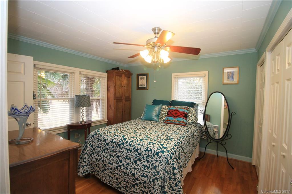 1748 Boyd Road Blackstock, SC 29014 - Photo 20 of 24 a bedroom with a bed and a chandelier