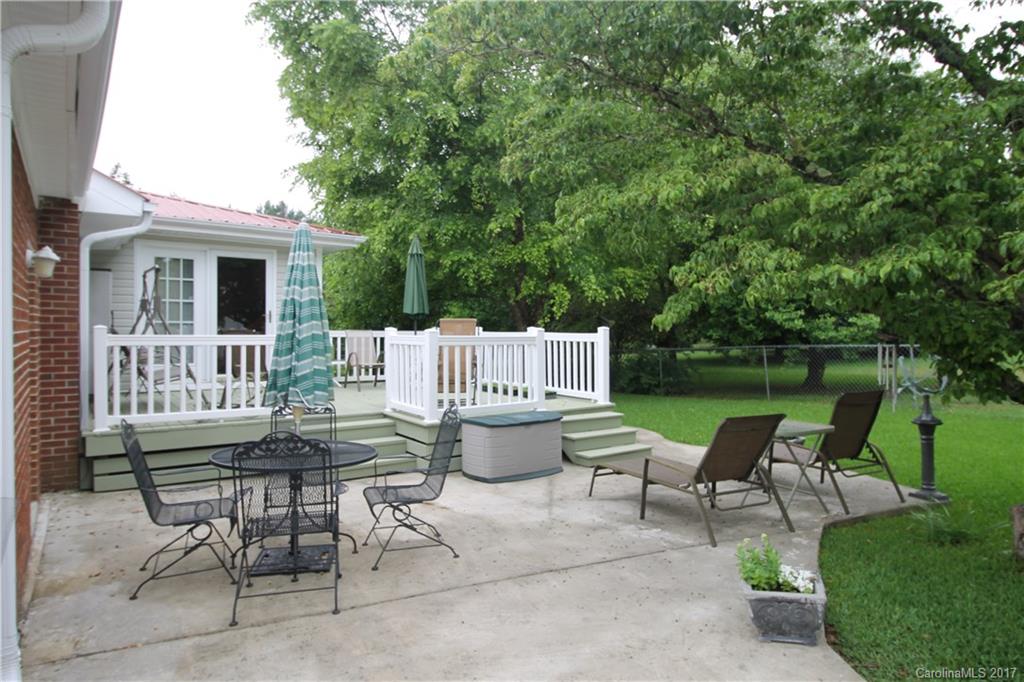 1748 Boyd Road Blackstock, SC 29014 - Photo 5 of 24 a view of a patio with table and chairs potted plants and a large tree