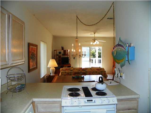 209 Blue Mountain Beach Road, Unit 401 Santa Rosa Beach, FL 32459 - Photo 5 of 8 a kitchen with a stove and a wooden floor