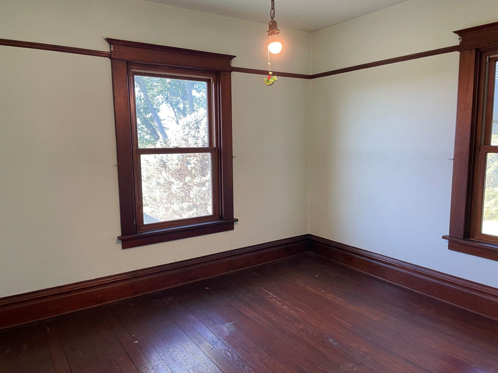3076 Alworth Road Winnebago, IL 61088 - Photo 15 of 28 a view of an empty room with wooden floor and a window