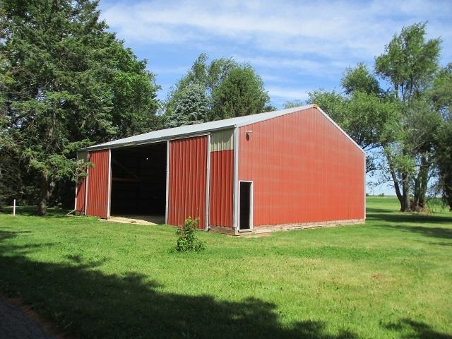 3076 Alworth Road Winnebago, IL 61088 - Photo 20 of 28 a view of a backyard with potted plants and large trees
