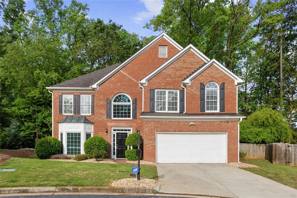 3193 Arbor Ridge Court Atlanta, GA 30340 - Photo 1 of 1 a front view of a house with a yard and garage