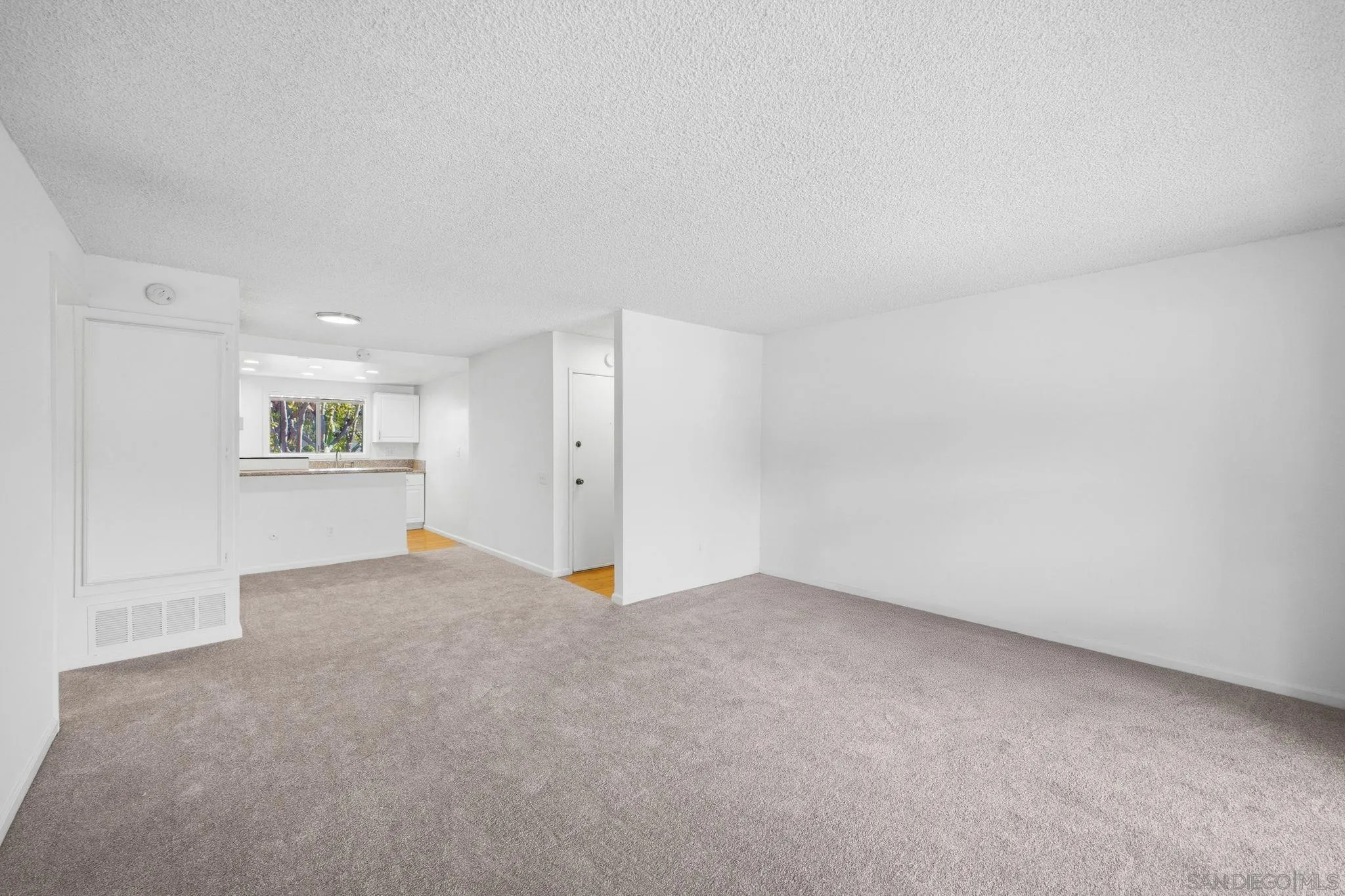 6019 Rancho Mission Road, Unit 204 San Diego, CA 92108 - Photo 38 of 38 Spacious living room & open floor plan to kitchen