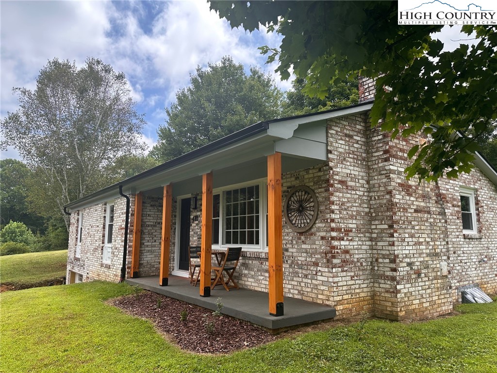 410 Cook Street Jefferson, NC 28640 - Photo 2 of 16 a view of a house with backyard porch and garden