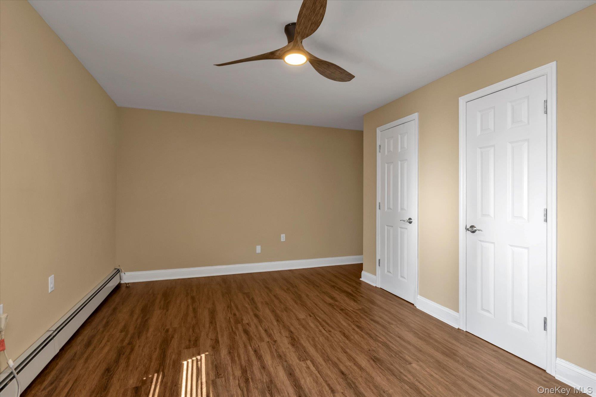 4 Rose Street, Unit 5H1 Oceanside, NY 11572 - Photo 11 of 18 a view of an empty room with wooden floor