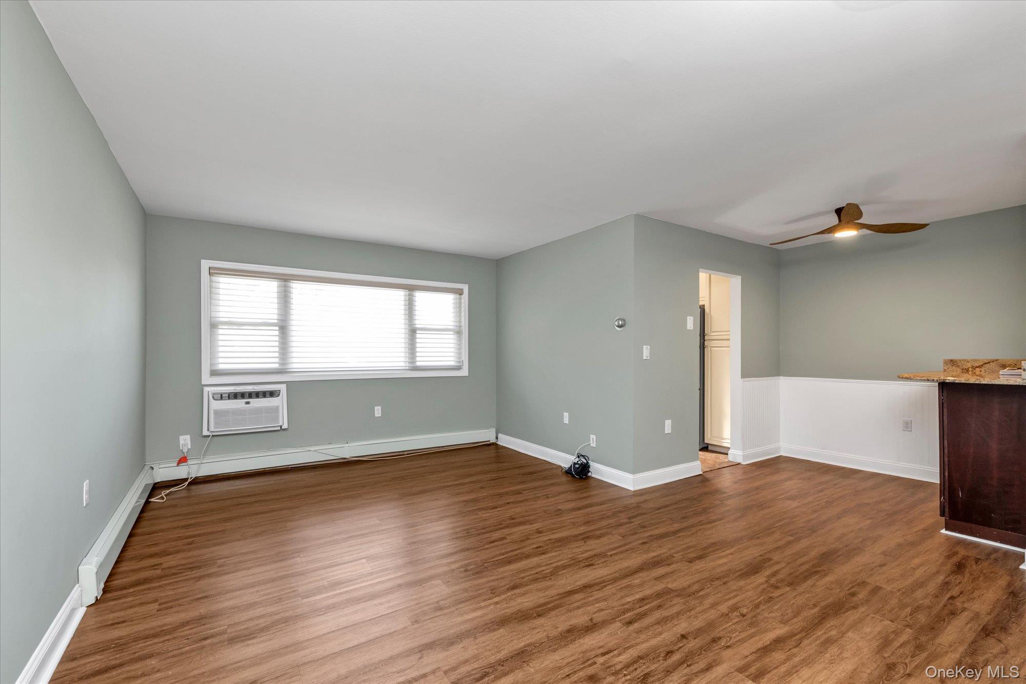 4 Rose Street, Unit 5H1 Oceanside, NY 11572 - Photo 3 of 18 a view of wooden floor and windows in a room