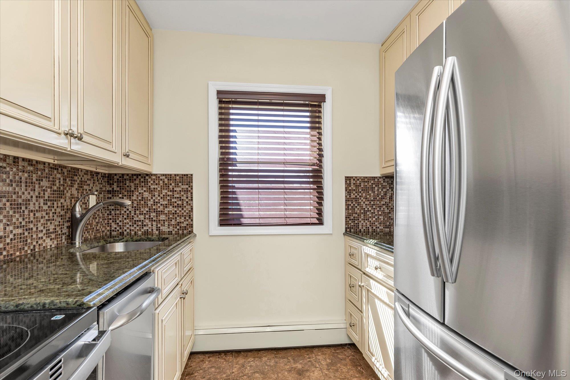 4 Rose Street, Unit 5H1 Oceanside, NY 11572 - Photo 8 of 18 a kitchen with a refrigerator and window