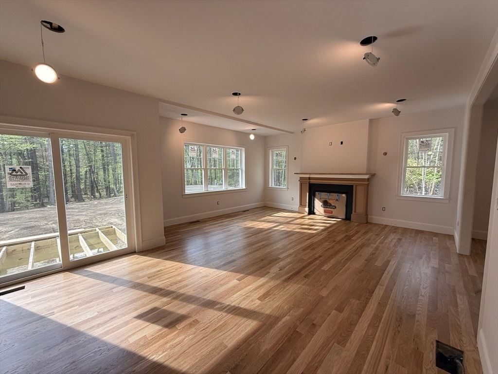 120 Maple Street Stow, MA 01775 - Photo 9 of 36 a bedroom with a bed and a fireplace