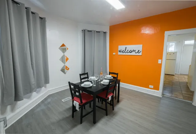 a view of a dining room with furniture and wooden floor