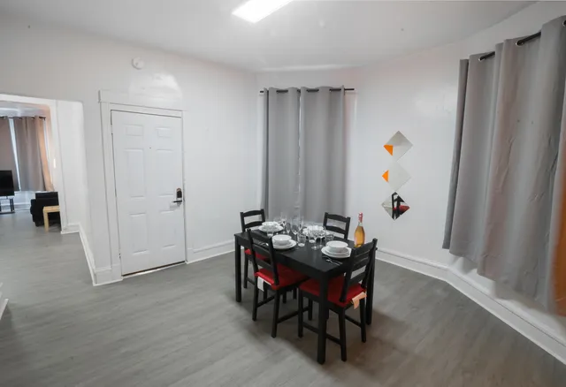 a view of a dining room with furniture and window