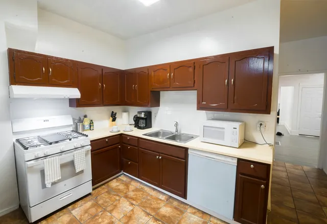 a kitchen with a sink stove and cabinets
