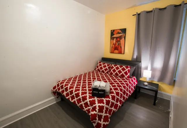 a bed sitting in a bedroom next to a window