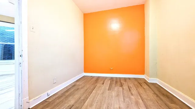 a view of a room with wooden floor