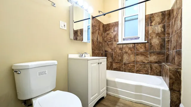 a bathroom with a sink a toilet and bathtub