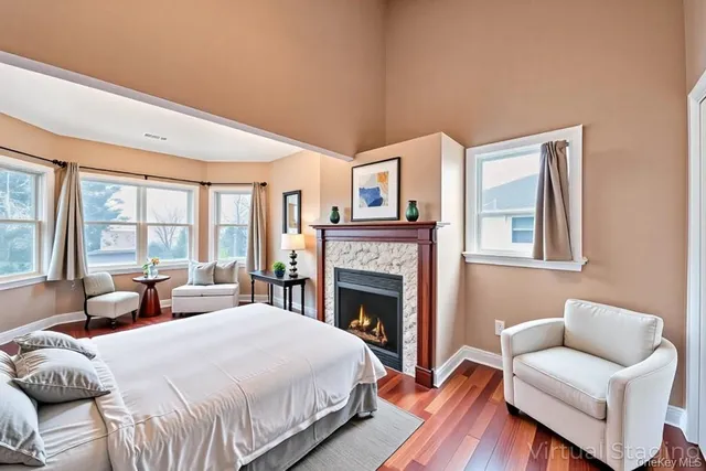 a spacious bedroom with a bed and wooden floor