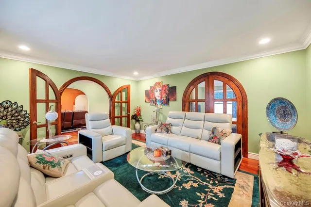a living room with furniture a rug and white walls