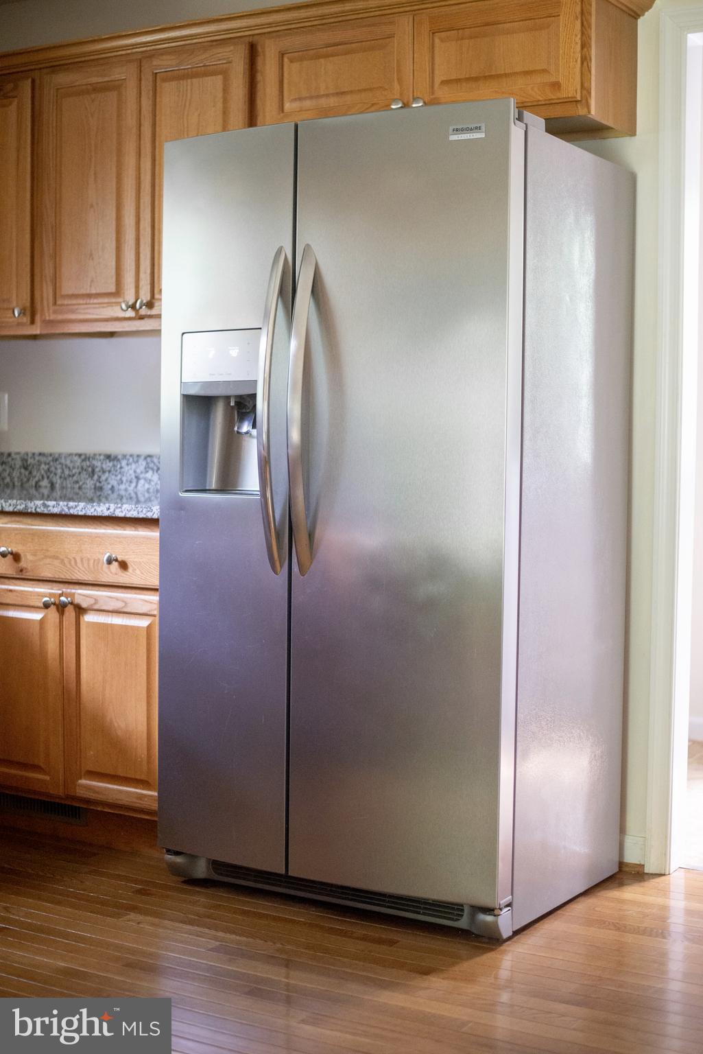 5588 Courtneys Corner Road Sumerduck, VA 22742 - Photo 11 of 22 a kitchen with metallic refrigerator freezer and a dishwasher