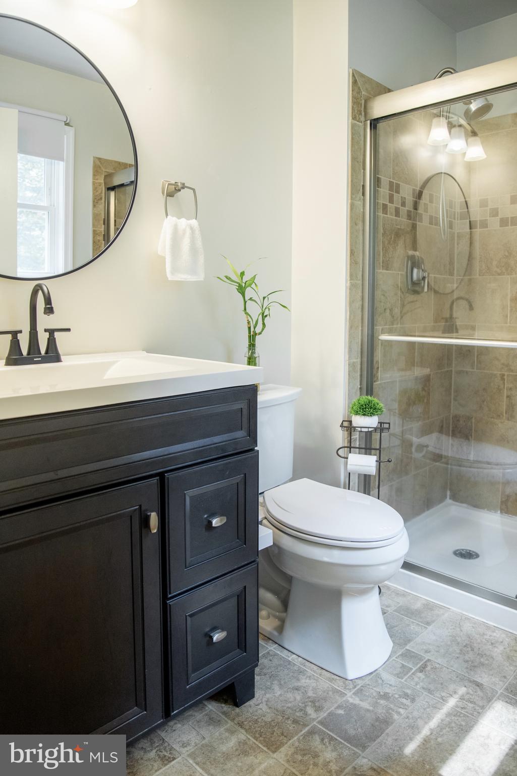 5588 Courtneys Corner Road Sumerduck, VA 22742 - Photo 17 of 22 a bathroom with a toilet a sink and mirror