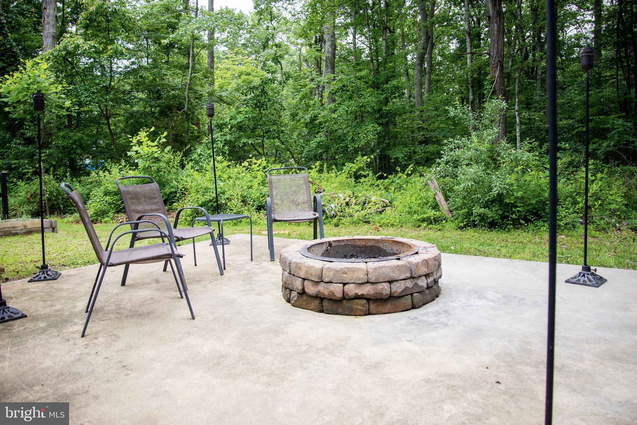 5588 Courtneys Corner Road Sumerduck, VA 22742 - Photo 19 of 22 a backyard of a house with table and chairs