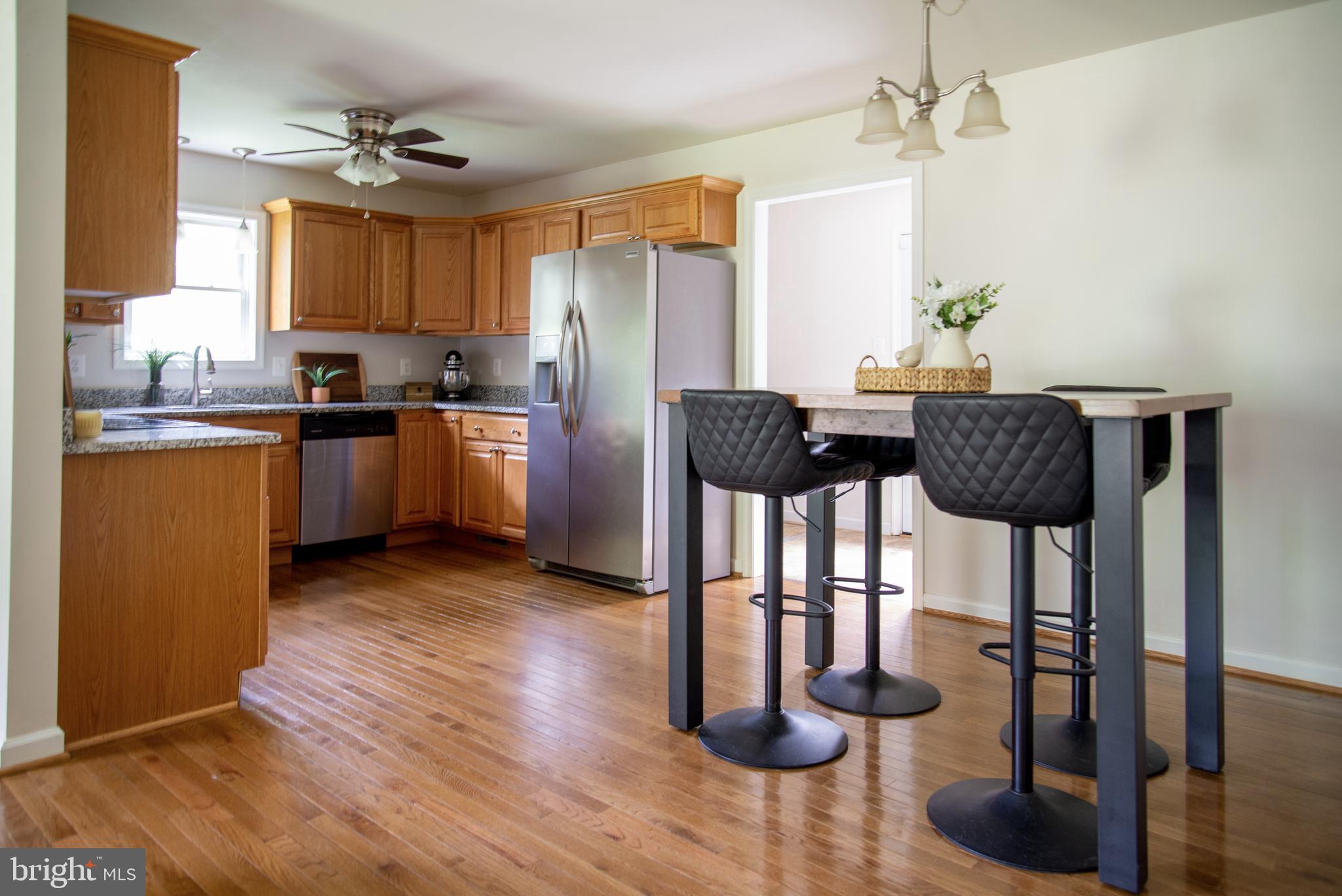 5588 Courtneys Corner Road Sumerduck, VA 22742 - Photo 6 of 22 a kitchen with granite countertop cabinets and stainless steel appliances