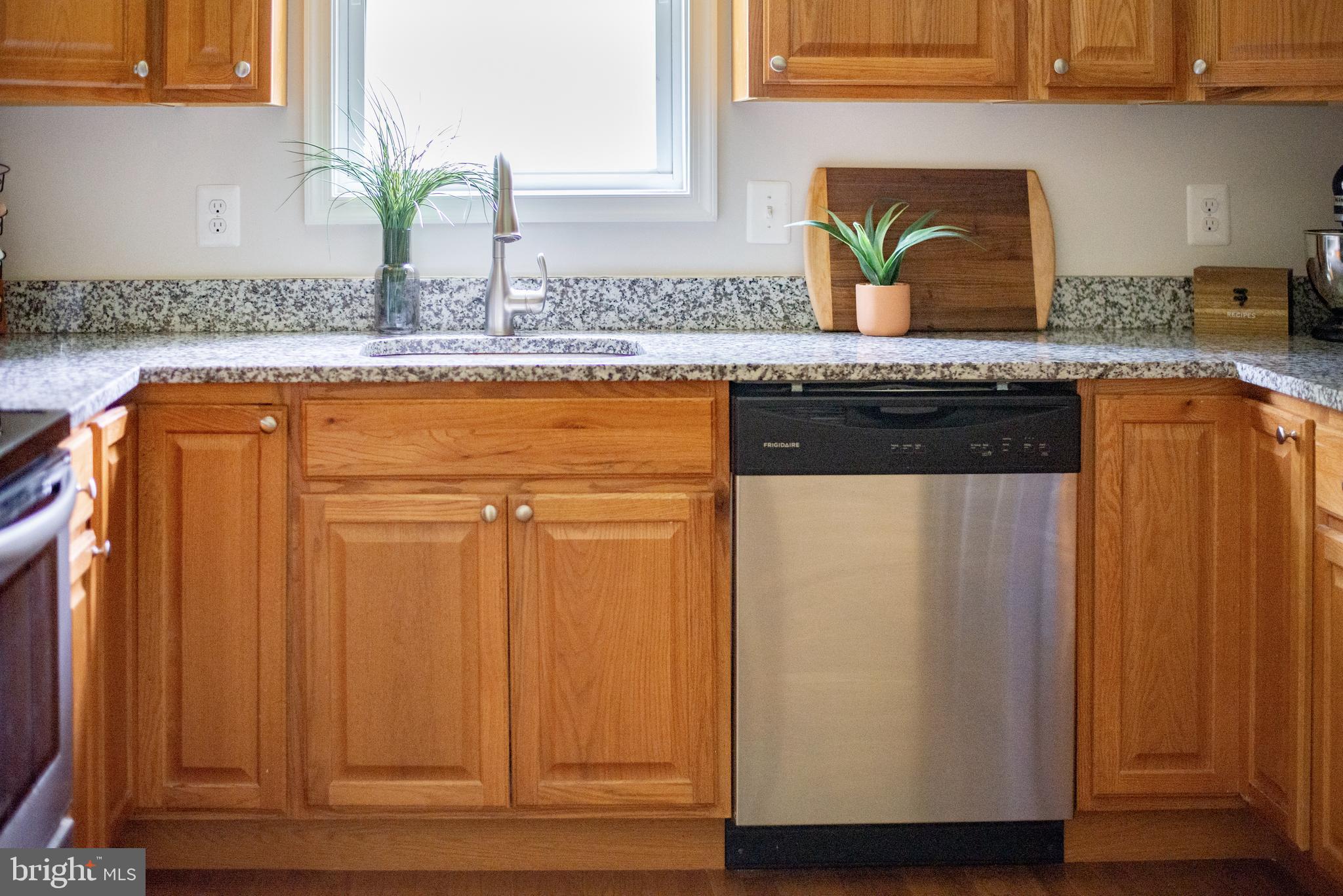 5588 Courtneys Corner Road Sumerduck, VA 22742 - Photo 10 of 22 a kitchen with granite countertop cabinets and white appliances