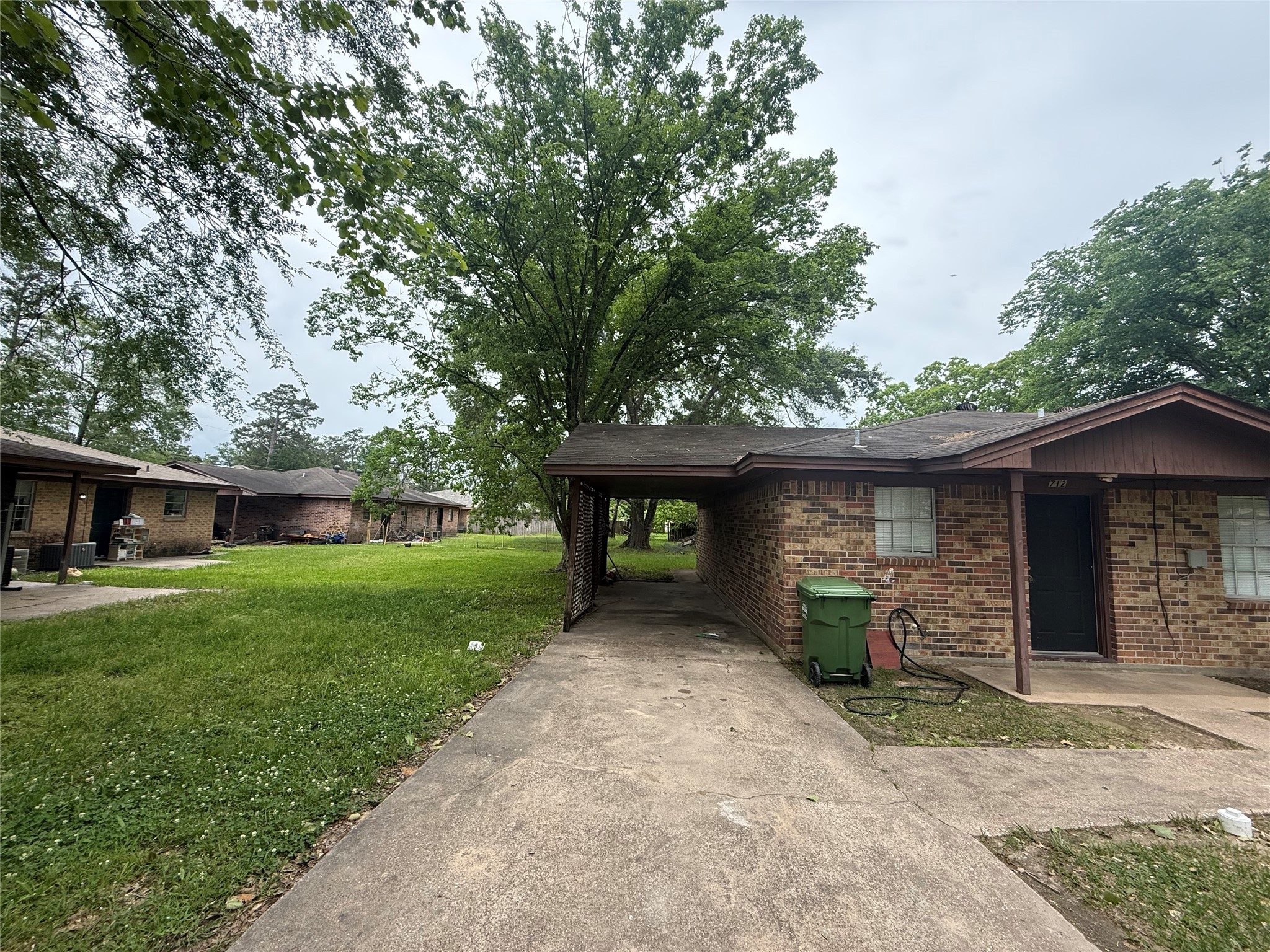 1409 Truman Street, Unit 1411 Cleveland, TX 77327 - Photo 5 of 8 a front view of a house with garden