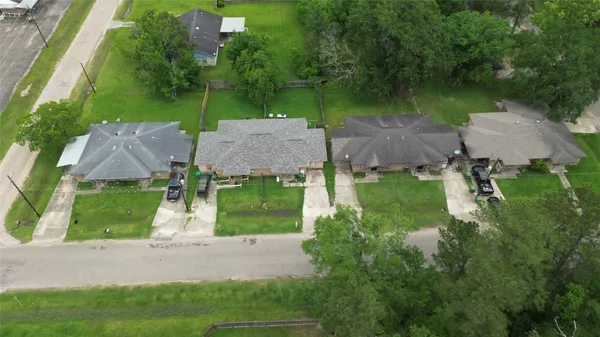 an aerial view of a house with garden space and street view