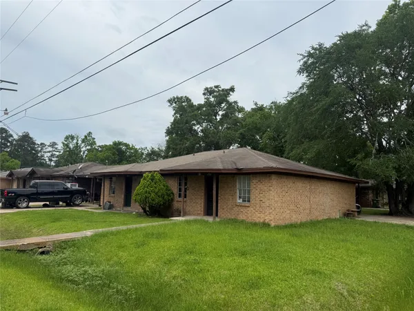 a view of a house with a yard potted plants