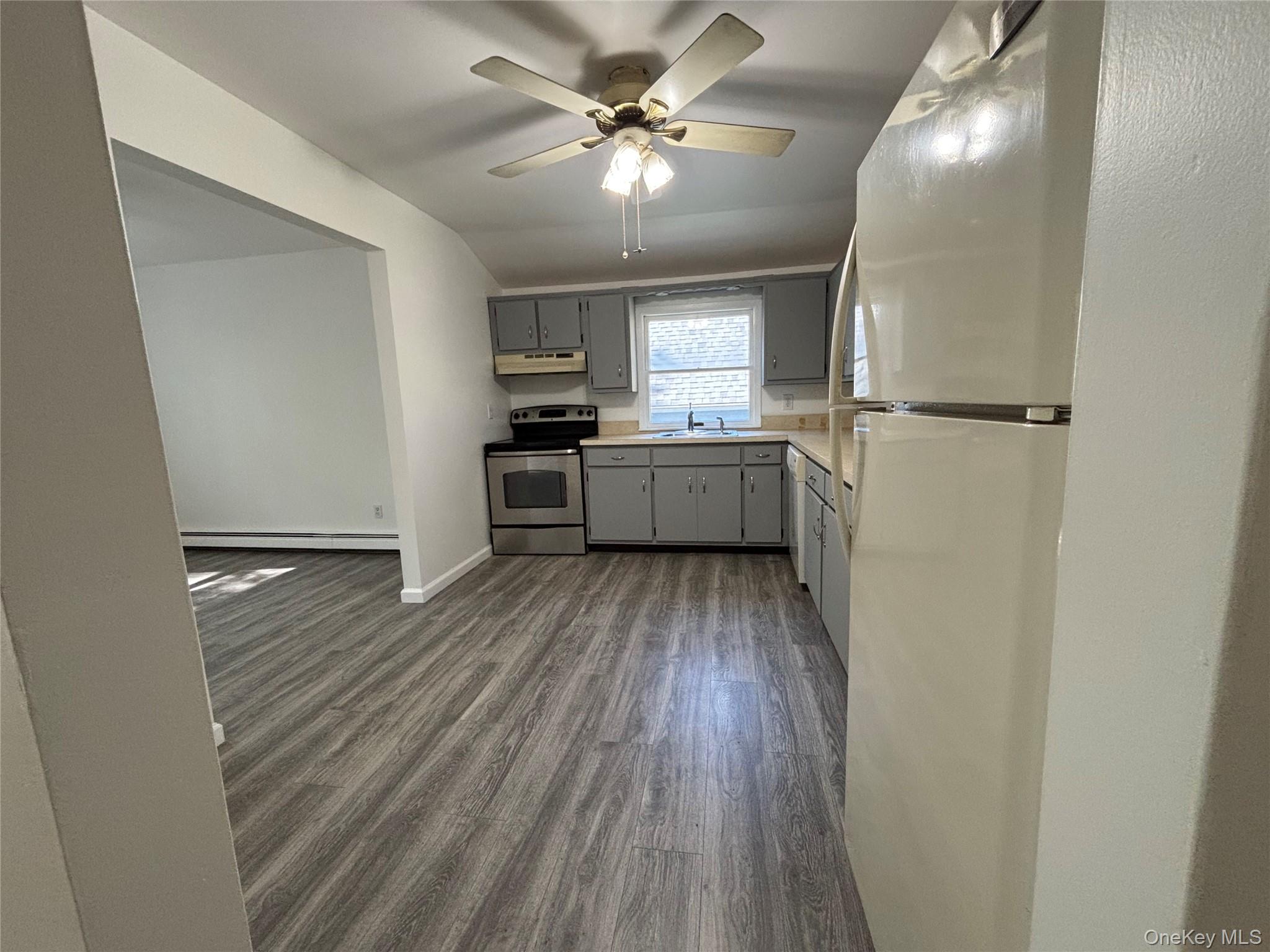 679 A Meadow Road Smithtown, NY 11787 - Photo 20 of 30 Kitchen featuring gray cabinets, freestanding refrigerator, dark wood finished floors, electric stove, and light countertops