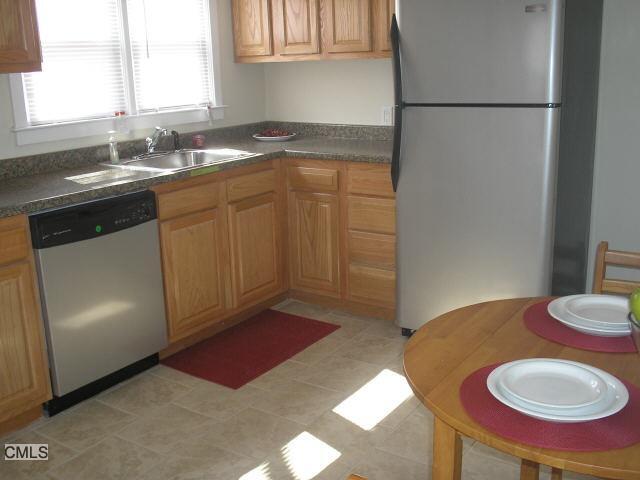 a kitchen with sink refrigerator and window