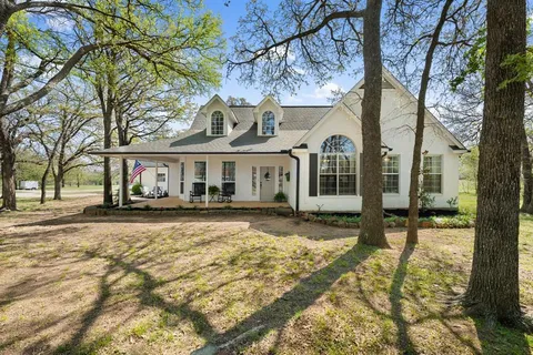 a view of a house with a yard in the background