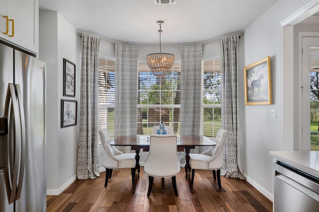 965 Stonecrest Road Argyle, TX 76226 - Photo 14 of 30 a view of a dining room with furniture window and wooden floor