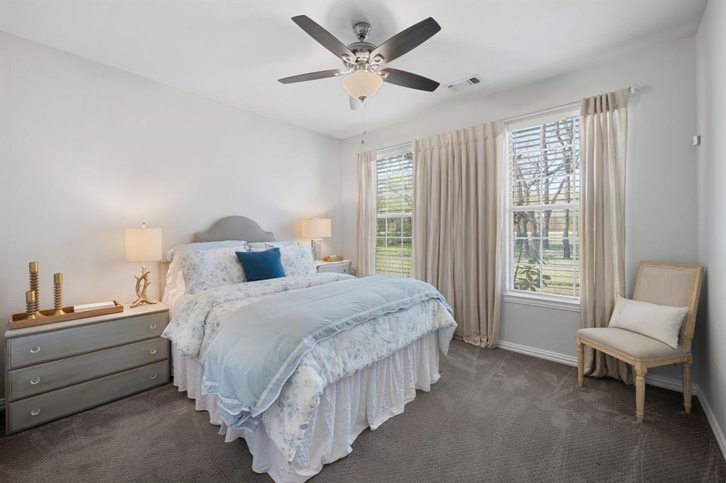 965 Stonecrest Road Argyle, TX 76226 - Photo 21 of 30 a spacious bedroom with a bed and a chair