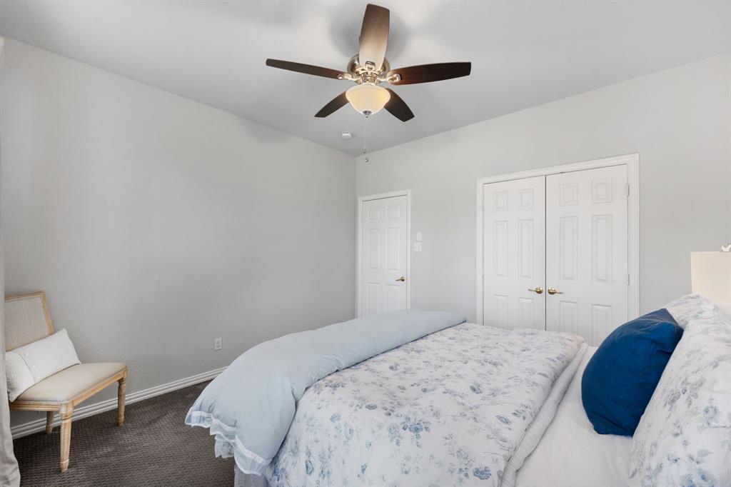 965 Stonecrest Road Argyle, TX 76226 - Photo 22 of 30 a bedroom with a bed and a ceiling fan