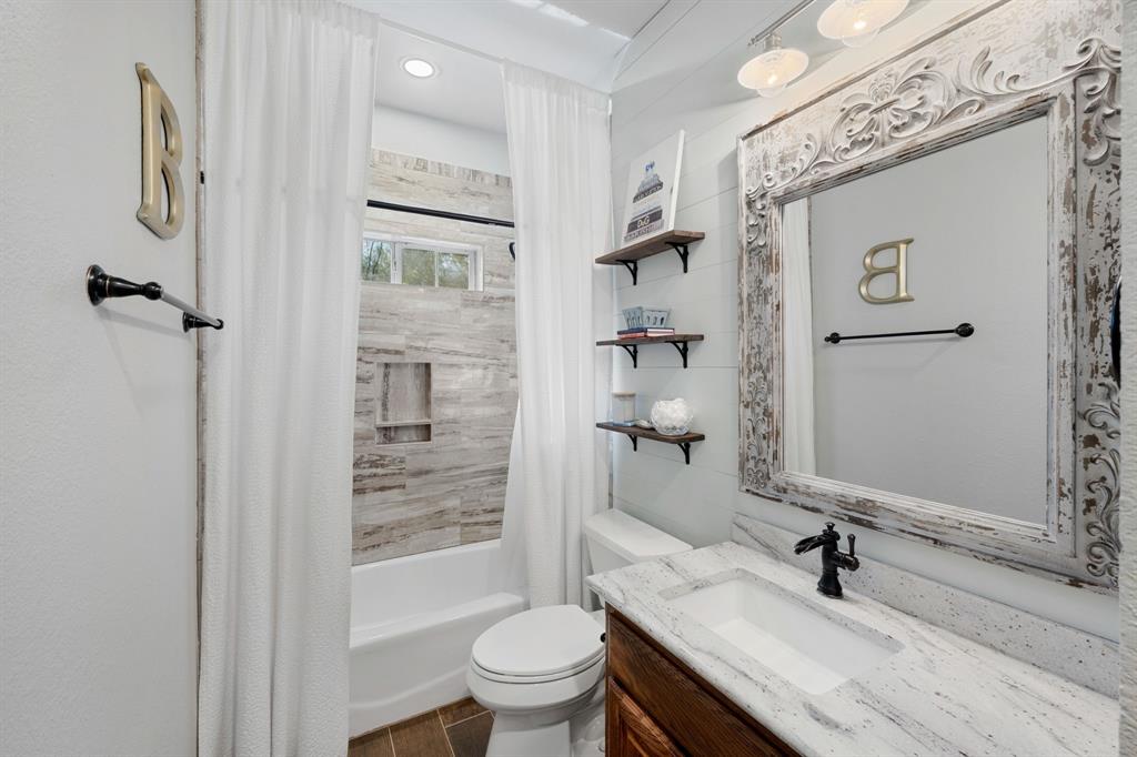 965 Stonecrest Road Argyle, TX 76226 - Photo 23 of 30 a bathroom with a granite countertop sink toilet and shower