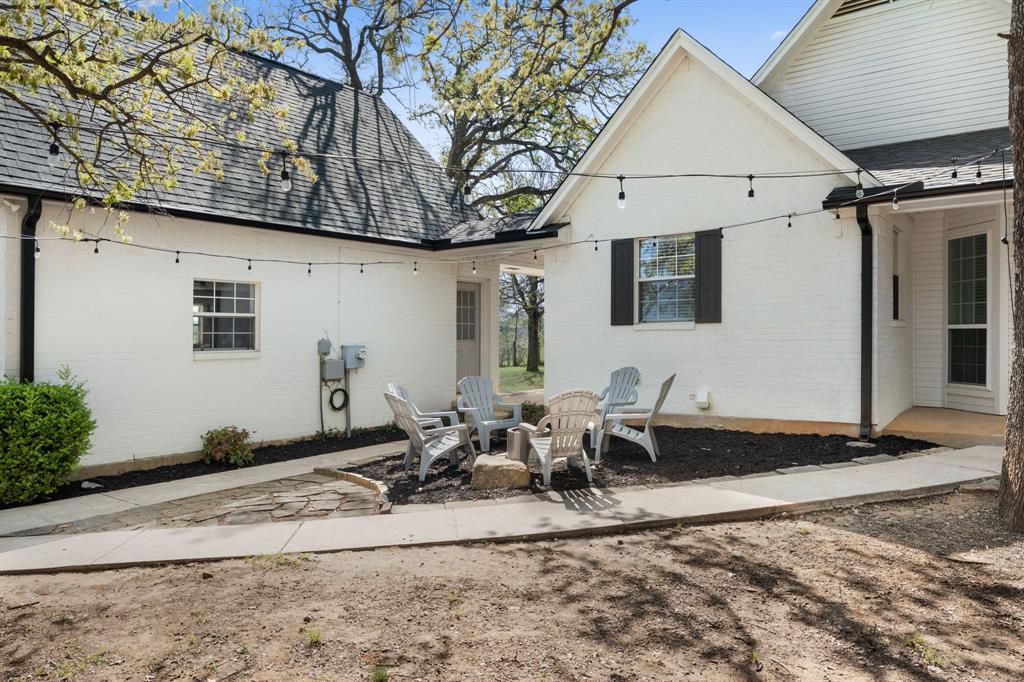 965 Stonecrest Road Argyle, TX 76226 - Photo 3 of 29 Side of house has a breezeway to the garage and nights can be spent around a firepit area.