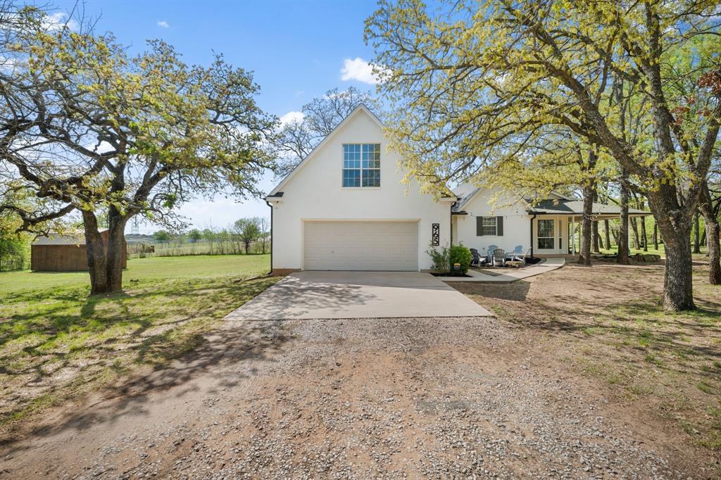 965 Stonecrest Road Argyle, TX 76226 - Photo 4 of 29 Traditional-style home with driveway leading to a detached oversized 2 car garage that has space above for a full conversion. The garage has a closet, built in cabinets and bumpouts.