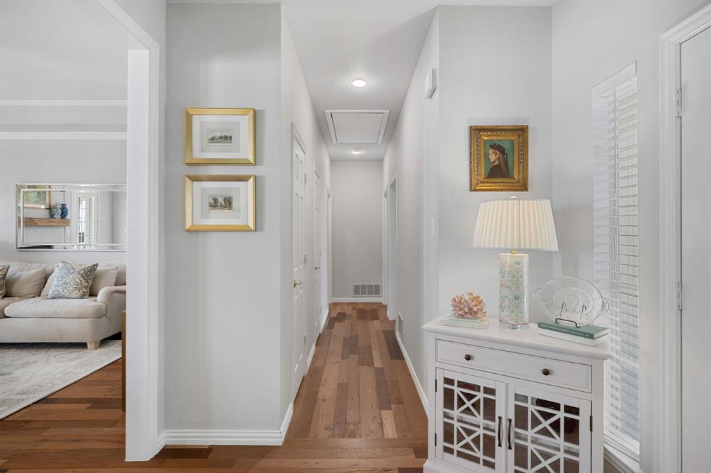 965 Stonecrest Road Argyle, TX 76226 - Photo 6 of 29 Hallway featuring hardwood flooring that leads to split bedrooms and full bath.