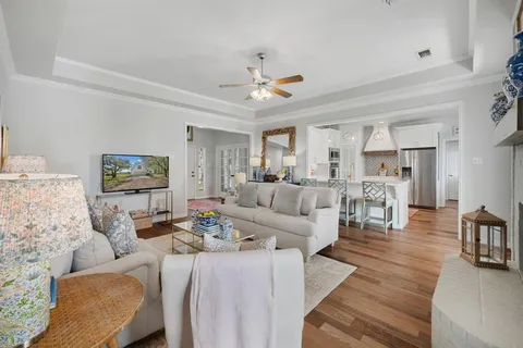 a living room with furniture and a chandelier