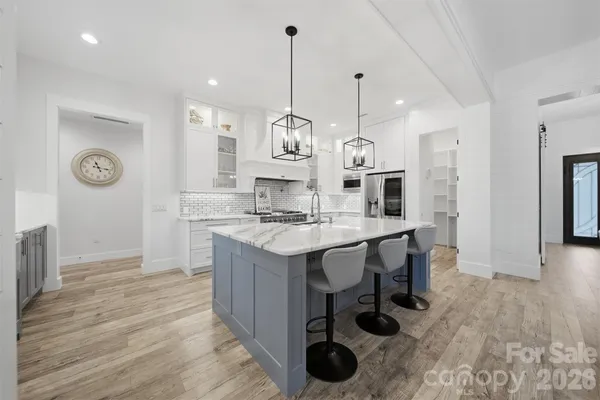 a kitchen with granite countertop a sink a counter space and stainless steel appliances