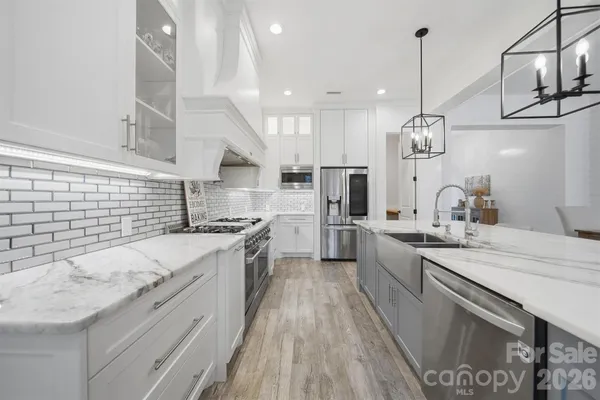 a large kitchen with stainless steel appliances kitchen island a large island in the center