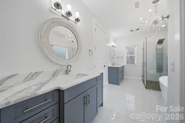 a bathroom with a granite countertop sink a toilet and a mirror