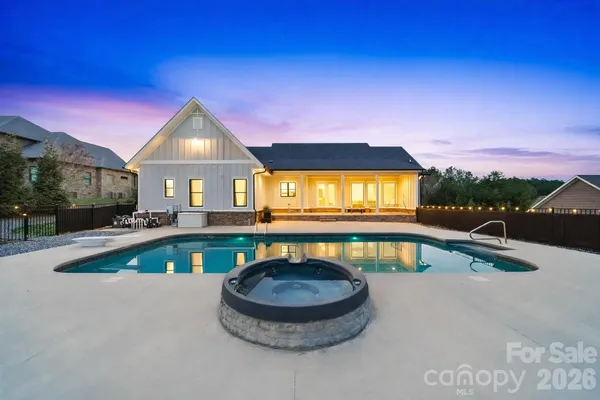 a view of a house with swimming pool and sitting area