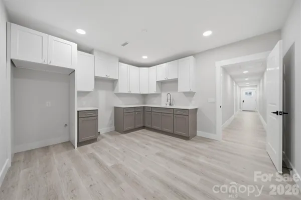 a large kitchen with stainless steel appliances granite countertop a stove a sink and a refrigerator