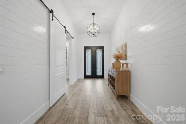 a view of hallway with wooden floor
