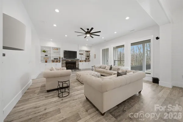 a living room with furniture a fireplace and a flat screen tv