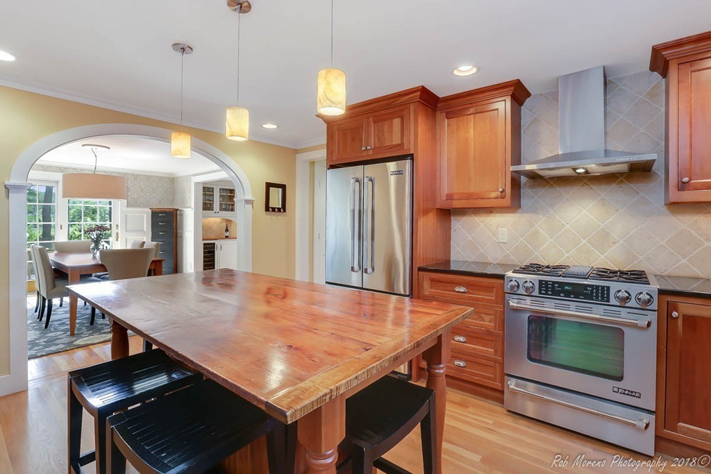 20 Wilmor Road Topsfield, MA 01983 - Photo 4 of 30 a kitchen with stainless steel appliances granite countertop a stove a refrigerator a oven a sink with a dining table and chairs