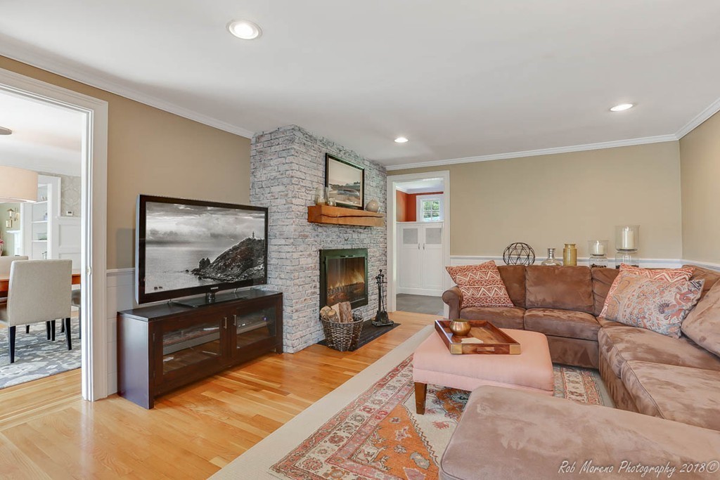20 Wilmor Road Topsfield, MA 01983 - Photo 9 of 30 a living room with furniture a flat screen tv and a fireplace